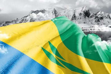 Saint Vincent and the Grenadines national flag cloth fabric waving on beautiful ice Mountain Background. - obrazy, fototapety, plakaty