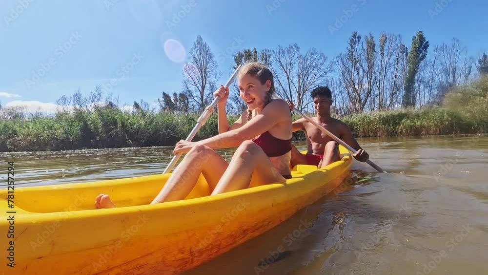 Wall mural Boat, kayak and couple on river in nature for holiday, summer vacation and weekend outdoors. Water sports, travel and man and woman in canoe on lake for adventure, fun activity and hobby together