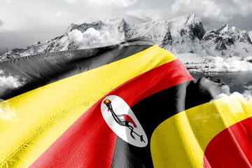Uganda national flag cloth fabric waving on beautiful ice Mountain Background.