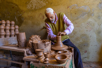 Traditional artisan crafting pottery in a workshop