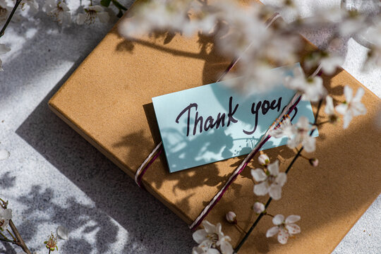 Thank You Note and Gift Box Amidst Cherry Blossoms