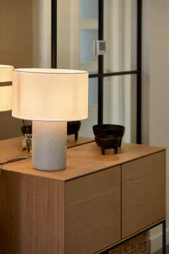 Elegant table lamp on a wooden sideboard in modern interior
