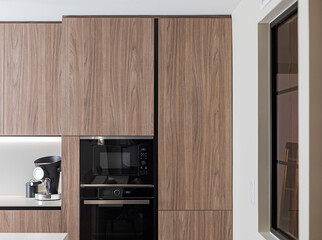 Modern kitchen with walnut cabinets and appliances