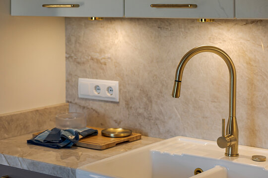 Luxurious gold faucet and marble in modern kitchen