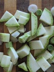 Sliced zucchini and onion on a wooden board. Fresh vegetables 