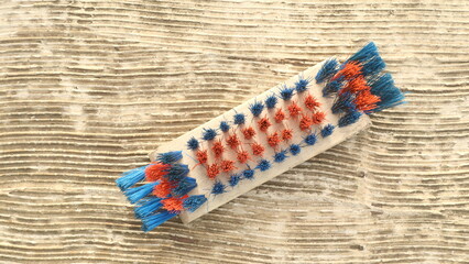 Brush with red and blue bristle for cleaning the floor