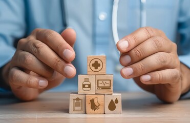 Hands of a person arranging wooden blocks featuring health and medical icons, Studio setting, wooden blocks, medical symbols concept