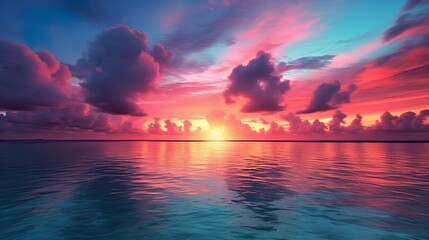 Captivating moment of the sun setting over the ocean, surrounded by a spectacle of pink and blue clouds