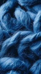 A close-up view showcases a background of blue felting wool, capturing its texture and richness in detail, ideal for creative projects or design inspiration.