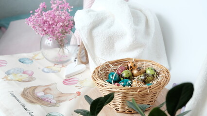 Composition of eggs painted for Easter in a basket and Gypsophila flowers .