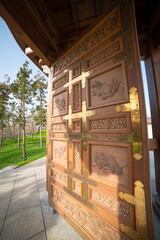 The karamon or karakado is a gate in Japanese architecture. Fragment of wooden facade Karamon gate of central entrance in the public landscape Japanese style park	