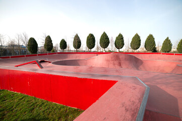 Empty public pink skate park waiting for skaters. Skateboard in city. Skate and Bike Park. Extreme...