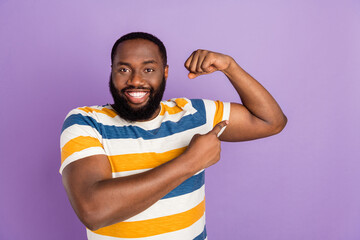 Photo portrait of handsome young guy show point muscles flexing dressed stylish striped garment...