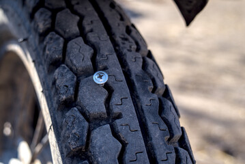 Metal screw in motorcycle tire.