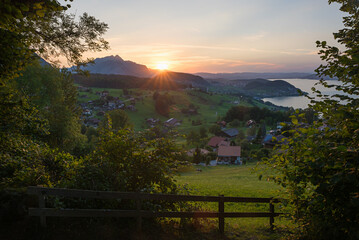 view from lookout point above tourist resort Krattigen, lake Thunersee at sunset