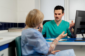 consultation between a doctor and an elderly patient in a plastic surgery clinic