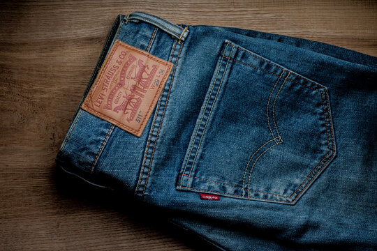 Kharkiv, Kharkiv region Ukraine - 04.09.2024: Blue Levi's jeans on wooden table