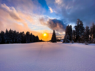 Colorful sunset in winter on a snow-covered, untouched mountain