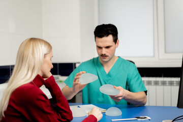 in a plastic surgery clinic a doctor talks about implants for a young girl for augmentation