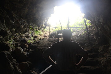 Cave Expedition: Explorer Gazing Outward with Hat