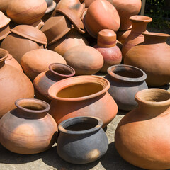 Clay pots are sold in a street market.