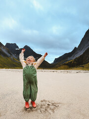 Happy child walking on the beach in Lofoten islands travel family vacations outdoor active healthy lifestyle, girl 4 years old kid exploring Norway adventure trip - 781305266