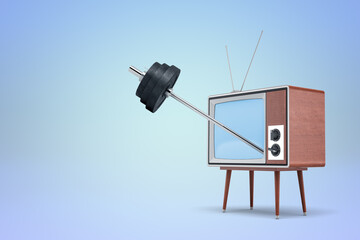 Retro TV lifting weights on blue background