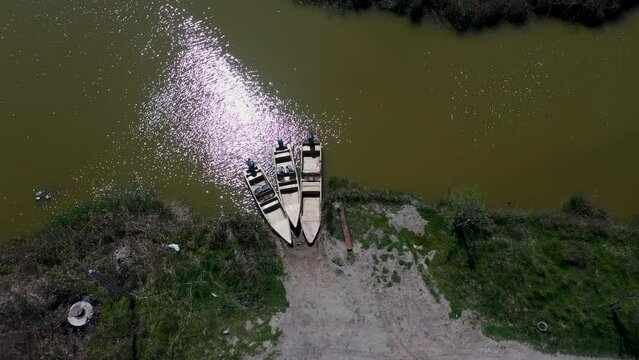 3 boats with a motor are parked in the channel. Aerial photography, top view