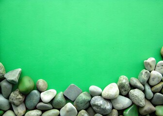 The background is green. Green stones lie smooth, the background is made of green stones. good image quality