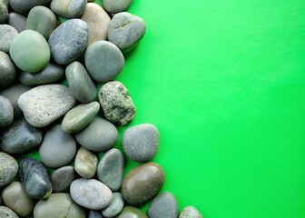 The background is green. Green stones lie smooth, the background is made of green stones. good image quality