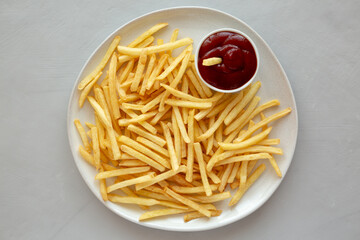 Fried French Fries with Ketchup on a Plate, top view. Flat lay, overhead, from above.