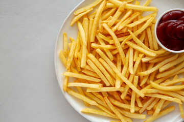 Fried French Fries with Ketchup on a Plate, top view. Flat lay, overhead, from above.