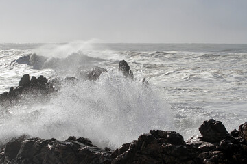 Small cape being hit by strong stormy sea waves - 781316697