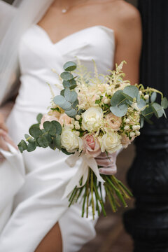 Close-up of bride hold bouquet in hands. Elegant wedding dress. Beautiful wedding bouquet 