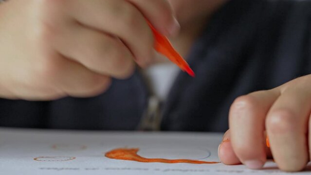 Little Boy Chats While Coloring His Sketchbook Using Colored Pen