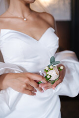 Close-up of gorgeous bride in beautiful wedding dress hold flowers in hands and waiting for groom