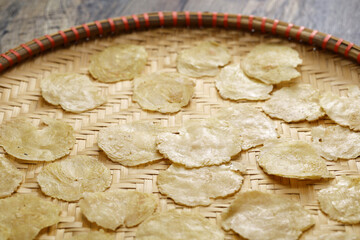 Emping, Indonesian crackers made from crushed Belinjo nuts. Drying on a bamboo tray.