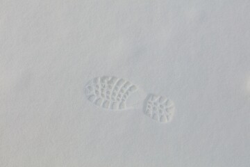 Closeup of footprint in fresh snow in winter.