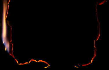 burning paper, glowing edge of paper on a black background