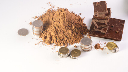 Cocoa Powder Chocolate Bar Coins. Chunks of chocolate, money on white background concept of rising...