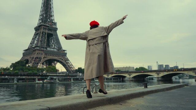 Person Balancing by the Seine with Eiffel Tower View