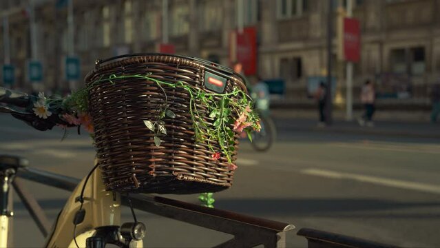 Wicker Bicycle Basket with Flowers on City Street