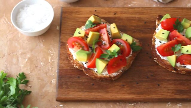 Toast with white cheese, tomatoes and avocado. Healthy eating. Vegetarian food.