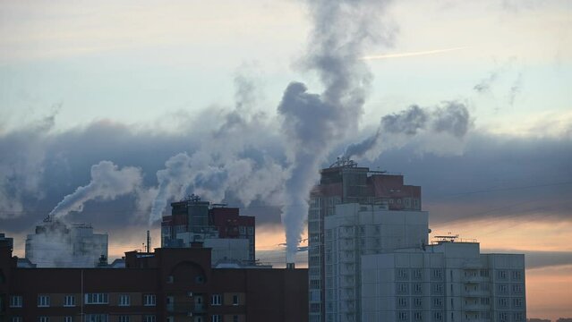 Environmental pollution concept. Hot steam rising from residential buildings. Time lapse of steam and clouds