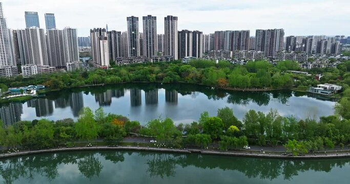 Beautiful Chengdu aerial Cityscape at spring Cloudy day with lake river park and lush woods