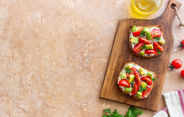 Toast with white cheese, tomatoes and avocado. Healthy eating. Vegetarian food.