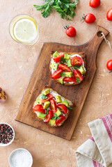 Toast with white cheese, tomatoes and avocado. Healthy eating. Vegetarian food.