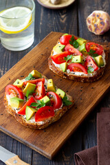 Toast with white cheese, tomatoes and avocado. Healthy eating. Vegetarian food.