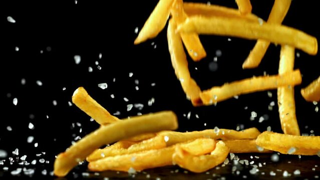 Super slow motion French fries are deep-fried in oil. High quality FullHD footage