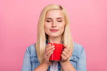 Photo of young lovely lady enjoy aroma smell dreamy mug cappuccino isolated over pink color...